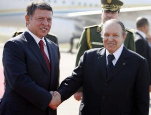Algeria's President Abdelaziz Bouteflika (R) shakes hands with Jordan's