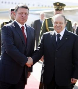 Algeria's President Abdelaziz Bouteflika (R) shakes hands with Jordan's