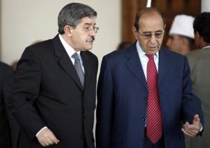 Algeria's Prime Minister Ahmed Ouyahia (L) listens to Interior