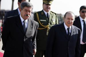 Algeria's President Abdelaziz Bouteflika walks with Algerian Prime Minister