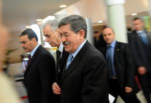 Algerian Prime Minister Ahmed Ouyahia (C) walks to the