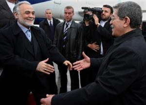 Algerian Prime Minister Ahmed Ouyahia (R) welcomes  Iran's