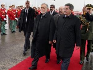 Algerian Prime Minister Ahmed Ouyahia (2R) escorts Iran's First