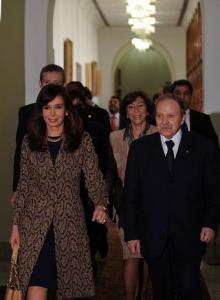 Algerian President Abdelazziz Bouteflika (R) walks with his Argentinian