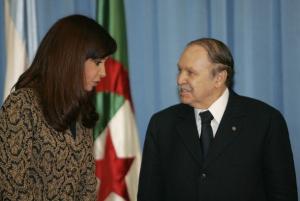 Algeria's President Abdelazziz Bouteflika (L) chats with his Argentinian